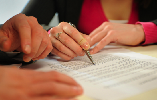 Two people reviewing through a document